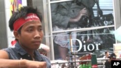 A young red shirt supporter sits at the movement's protest site in downtown Bangkok
