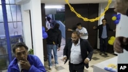 People run after presidential candidate Fernando Villavicencio was shot and killed after a campaign rally outside a school in Quito, Ecuador, Aug. 9, 2023.