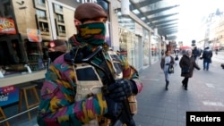 FILE - Belgian soldiers patrol in central Brussels as police search area during a continued high level of security following the recent deadly Paris attacks, Belgium, Nov. 23, 2015. 
