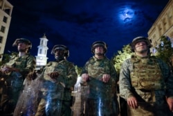 Utah National Guard soldiers stand on a police line as demonstrators gather to protest the death of George Floyd, June 4, 2020, near the White House in Washington.