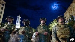 Utah National Guard soldiers stand on a police line as demonstrators gather to protest the death of George Floyd, June 4, 2020, near the White House in Washington. 