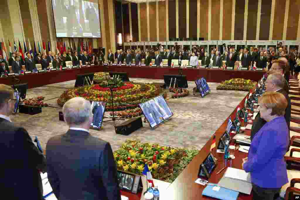 Leaders stand for a minute of silence for the victims of a deadly attack in the French city of Nice, before the opening session of the Asia-Europe Meeting (ASEM) summit in Ulaanbaatar, Mongolia, Friday, July 15, 2016.