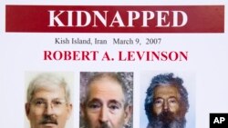 FILE- An FBI poster showing a composite image of former FBI agent Robert Levinson of how he would look like after years in captivity, and an image (center) taken from the video, released by his kidnappers.