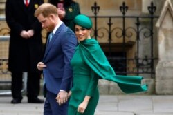 FILE - Britain's Harry, Duke of Sussex, and Meghan, Duchess of Sussex, arrive to attend the annual Commonwealth Service at Westminster Abbey in London, March 9, 2020.