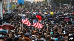 Pro-democracy protesters flood a street during a rally in Hong Kong, Dec. 1, 2019. 