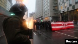 Police stand guard as climate activists protest at COP15 U.N. Biodiversity summit in Montreal, Quebec, Canada, Dec. 7, 2022.