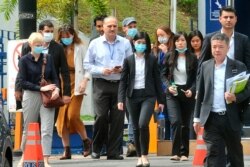 Staffs of news broadcaster Al Jazeera leave Bukit Aman police headquarters after being questioned by the Malaysian police over a documentary about the country's arrests of undocumented migrants, in Kuala Lumpur, Malaysia, July 10, 2020.