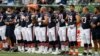 The Chicago Bears lock arms during the National Anthem in the first half of an NFL preseason football game against the Cincinnati Bengals, Aug. 9, 2018, in Cincinnati. 