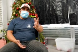 Gustavo Ajche, 38, who has three jobs, gestures after watching Joe Biden's presidential inauguration on TV at the offices of the Workers Justice Center, Jan. 20, 2021, in Brooklyn, N.Y.