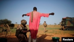 A French soldier of the 2nd Foreign Engineer Regiment searches a man during an area control operation in the Gourma region during Operation Barkhane in Ndaki, Mali, July 27, 2019. 