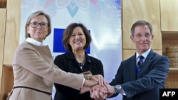 FILE - Revolutionary Alternative Force of the Common (FARC) Political party flags are seen during a protest in support of the Special Jurisdiction for Peace (JEP) in Bogota, Colombia, March 13, 2019. 