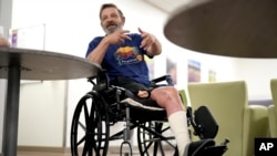 Ron Falk talks about losing his leg, June 25, 2024, in Phoenix, Arizona. Falk lost his right leg, had extensive skin grafting on the left one and is still recovering a year after collapsing on the searing asphalt outside a convenience store during a blistering heat wave.