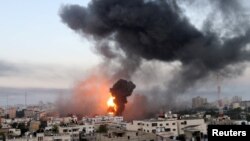 Smoke and flames rise during Israeli air strikes amid a flare-up of Israeli-Palestinian violence, in Gaza May 12, 2021. (REUTERS/Ibraheem Abu Mustafa)
