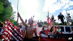 FILE - Native American protesters form a roadblock on the road leading to Mount Rushmore ahead of President Donald Trump's visit to the memorial on July 3, 2020, in Keystone, S.D. 