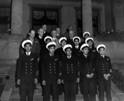 In this Aug. 1, 1945 photo, provided by the President Truman Library, President Harry S. Truman, in the third row, second from right, stands with members of his party and unidentified Filipino stewards during the Potsdam conference in Germany.