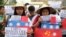FILE - Filipino student activists hold mock Chinese ships to protest recent island-building and alleged militarization by China off the disputed Spratlys group of islands in the South China Sea, during a rally in Manila, Philippines, March 3, 2016.