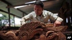 A woodworker from the Newar ethnic community labors in Lalitput, Nepal, July 19, 2017. In the rubble of Nepal's 2015 earthquake, dedicated woodworkers are re-creating what was lost, repairing beautifully hand-carved wooden doors and windows. 