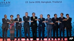 In this June 23, 2019, file photo, South East Asian leaders pose for a group photo during the opening ceremony of the ASEAN leaders summit in Bangkok, Thailand. (AP Photo/Gemunu Amarasinghe, File)