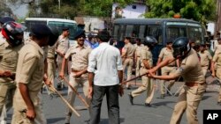 Indian policemen beat a lower caste Dalit protester during a nationwide strike in Ahmadabad, India, April 2, 2018.