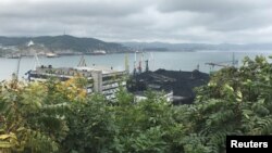 FILE - Piles of coal are seen in the Astafyev Cape area of the far eastern port of Nakhodka, Russia Sept. 5, 2017. 