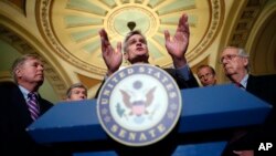 Sen. Bill Cassidy, R-La., center, speaks to the media, accompanied by Sen. Lindsey Graham, R-S.C., left, Sen. Roy Blunt, R-Mo., Sen. John Thune, R-S.D., and Senate Majority Leader Mitch McConnell of Ky., on Capitol Hill in Washington, Sept. 19, 2017.