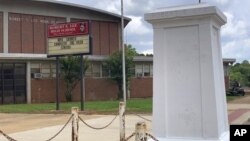 A pedestal that held a statue of Robert E. Lee stands empty outside a high school named for the Confederate general in Montgomery, Ala. on Tuesday, June 2, 2020. (AP Photo/Kim Chandler)