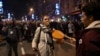 A demonstrator blows a whistle as opposition supporters take part in a march during a protest in Belgrade, on December 25, 2023, a week after the parliamentary and local elections in Serbia.