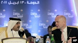 Britain's Foreign Secretary William Hague (R) talks with Qatar's Crown Prince Sheikh Tamim bin Hamad al-Thani before the start of the first contact group meeting on Libya in Doha, Qatar, April 13, 2011