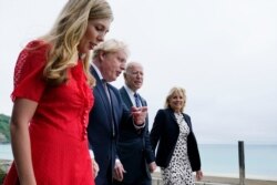 President Joe Biden and first lady Jill Biden are greeted and walk with British Prime Minister Boris Johnson and his wife Carrie Johnson, ahead of the G-7 summit, June 10, 2021.