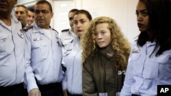 Ahed Tamimi, a 17-year-old from the West Bank village of Nebi Saleh, is brought to a courtroom inside Ofer military prison near Jerusalem, Dec. 28, 2017. 