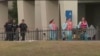 FILE - This photo taken from video provided by WEAR-TV shows emergency responders following a shooting incident at Naval Air Station Pensacola, in Pensacola, Florida, Dec. 6, 2019. 