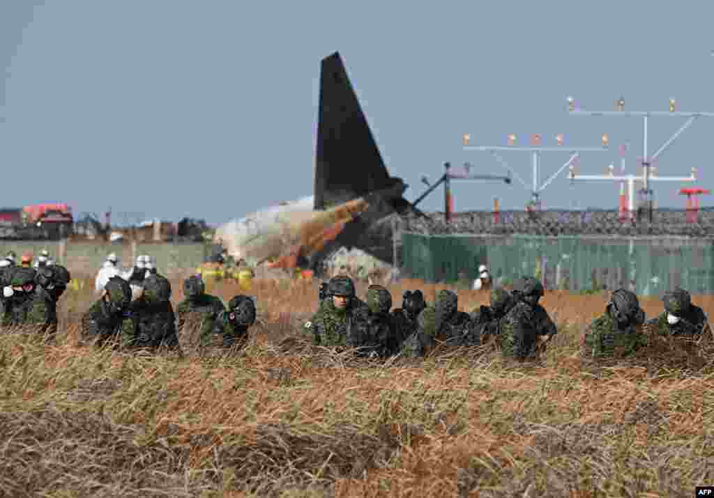 South Korean soldiers search for missing passengers near the wreckage of a Jeju Air Boeing 737-800 series aircraft at Muan International Airport in South Jeolla Province, some 288 kilometers southwest of Seoul, Dec. 29, 2024.