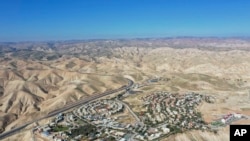 FILE - This Jan. 26, 2020, photo shows a view of the West Bank Jewish settlement of Mitzpe Yeriho. The United Nations Human Rights Council released a list of more than 100 companies it says are operating in Israel's West Bank settlements.