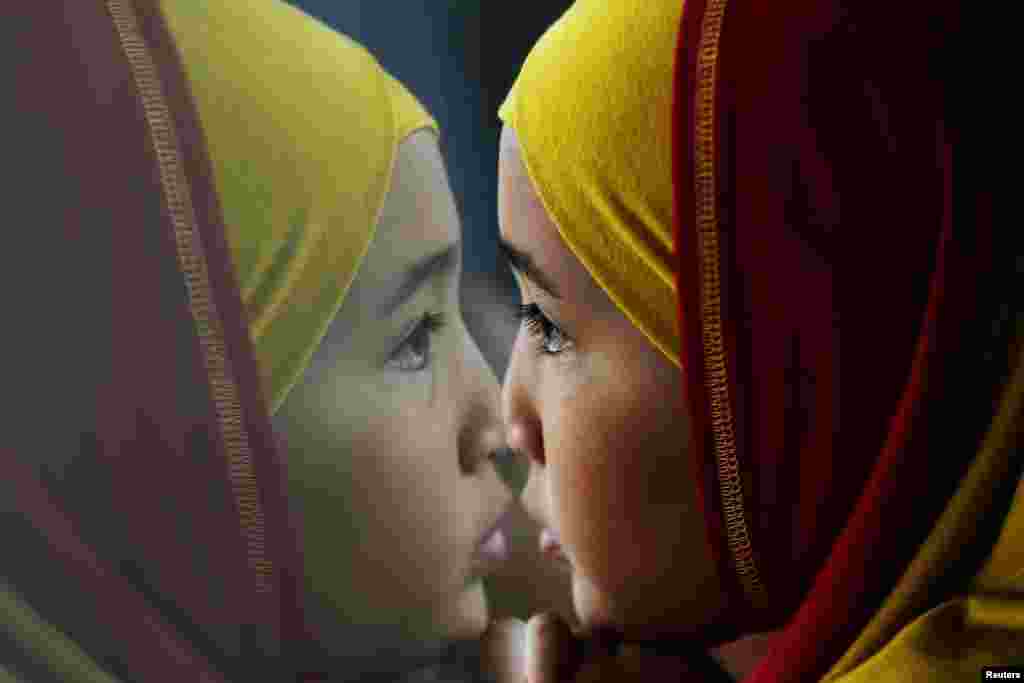 A girl looks at planes through the window of the departure hall at the Kuala Lumpur International Airport, Malaysia.