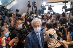 Pro-democracy activist Martin Lee, center, walks out from a court after receiving a suspended sentence in Hong Kong, April 16, 2021.