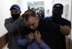 Ivan Safronov is escorted before a court hearing in Moscow, Russia, July 7, 2020.