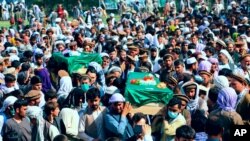 Afghans carry the body of civilians killed during fighting between the Taliban and Security forces, during their funeral in Badakhshan province, northern Afghanistan, July 4, 2021.