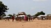 Malian children return from morning primary school session, which they attend in neighboring village, Sag-Nioniogo refugee camp, Burkina Faso, Oct. 9, 2013. (VOA/Jennifer Lazuta)