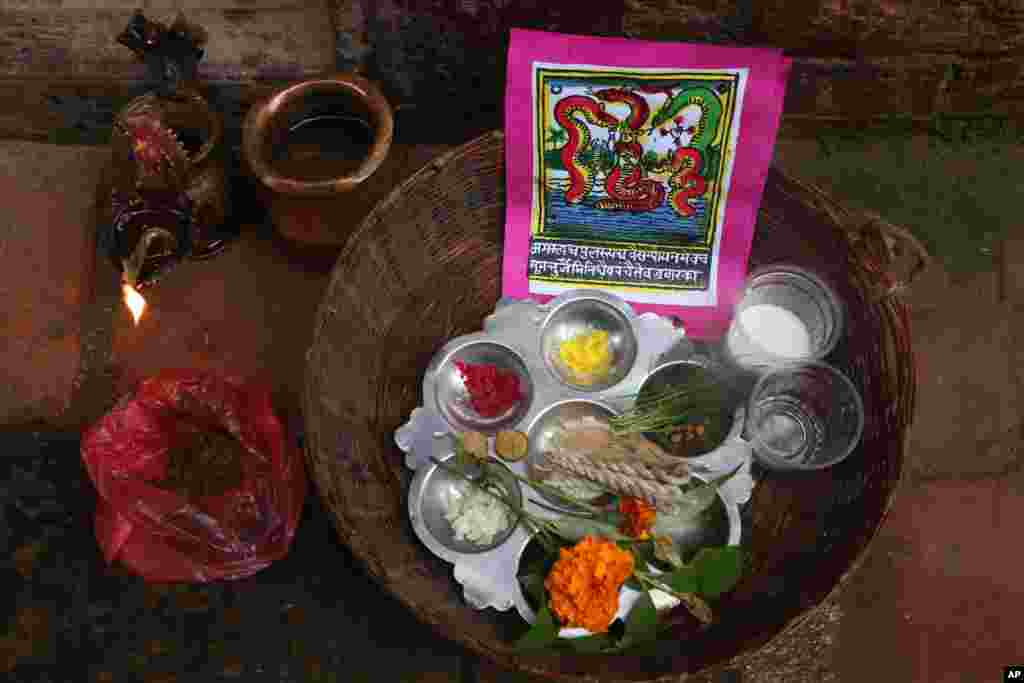 A traditional painting is seen in a basket containing materials used for rituals during Naag Panchami festival in Bhaktapur, Nepal, Aug. 5, 2019.