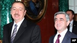 FILE- Azerbaijan President Aliyev, left, and Armenia President Sarkisian attend the CIS summit in Moscow, Dec. 10, 2010.