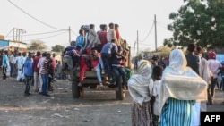 People fleeing intense fighting in Ethiopia's Tigray region gather in the bordering Sudanese village 8, east of the town of Gadaref, Nov. 13, 2020. 