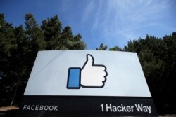 The thumbs-up Like logo is shown on a sign at Facebook headquarters in Menlo Park, Calif., April 14, 2020. Facebook's long-awaited oversight board is set to launch in October 2020.