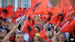 Supporters of the governing Socialist Party (PS) wave Albanian national flags during the closing electoral rally in capital Tirana, Albania, June 22, 2017. Albania holds parliamentary elections Sunday.