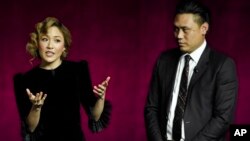 Police arrest a man during a crackdown on anti-coup protesters holding a rally in front of the Myanmar Economic Bank in Mandalay, Myanmar.