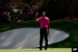 Tiger Woods holds up his ball after a birdie on the 13th hole during the first round at The Masters. (AP Photo/Matt Slocum)