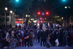 FILE - People protest in front of the Multnomah County Justice Center in Portland, Oregon, July 17, 2020.