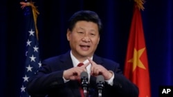 Chinese President Xi Jinping talks about how the Chinese symbol for the word "people" resembles two sticks supporting each other as he speaks Tuesday, Sept. 22, 2015.