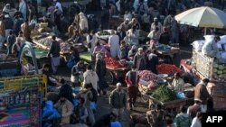 Traders and customers gather to bargain prices of commodities at a crowded vegetable market during a government-imposed nationwide lockdown as a preventive measure against the COVID-19 coronavirus, in Peshawar on April 2, 2020.