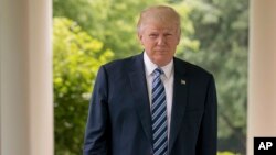 President Donald Trump walks along the West Wing Colonnade at the White House in Washington, April 21, 2017.