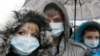 FILE - Ukrainians wearing medical masks demonstrate in front of the memorial monument to AIDS victims in Kyiv, Ukraine.